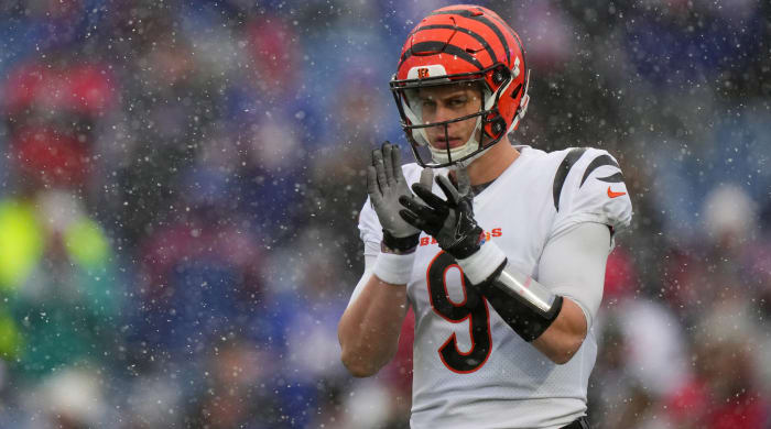 Bengals quarterback Joe Burrow warms up before an NFL divisional playoff football game.